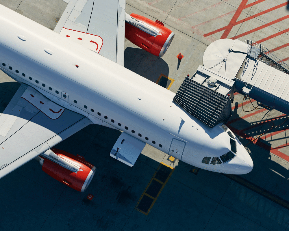 Commercial aircraft at airport gate during irregular operations, illustrating airline disruption and IROPs management challengesf