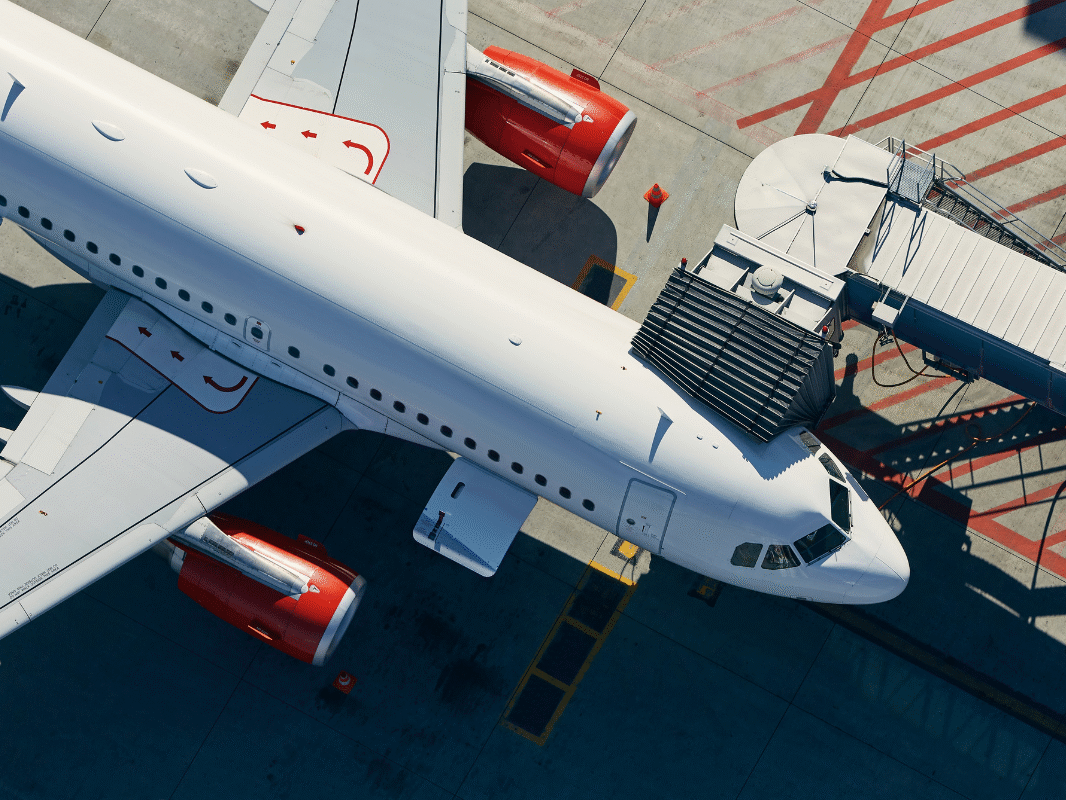 Commercial aircraft at airport gate during irregular operations, illustrating airline disruption and IROPs management challengesf